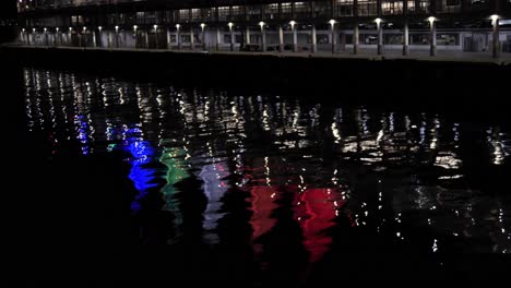 4k-CANADA-PLACE-Sails-of-Light-at-Night-Reflections-on-water,-Downtown-Vancouver-British-Columbia,-seen-from-Stanley-Park-sea-wall