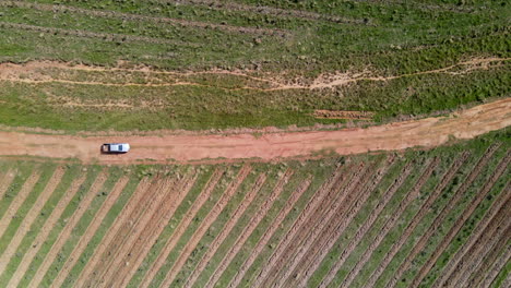 aerial-view-of-white-truck-on-dirt-road