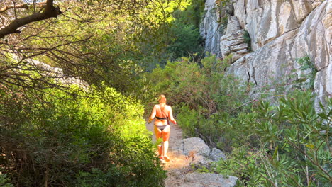 Overweight-girl-hiking-in-bikini-in-nature-forest-in-Andalucia-Spain,-healthy-sporty-activity-with-mountains-and-green-trees-on-a-hike,-weight-loss-journey,-losing-weight,-4K-shot