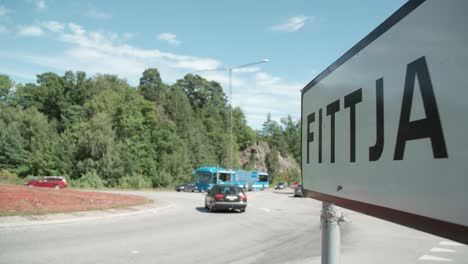 Busy-roundabout-with-sign-of-Fittja-in-the-foreground,-Sweden