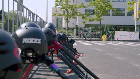 Helmets-On-Scooters,-Push-Bikes-At-A-Recreational-Park-In-Amsterdam