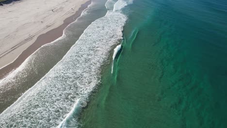 Fly-Over-Foamy-Sea-Waves-On-The-Spit-Dog-Beach-In-Queensland,-Australia