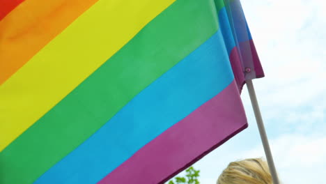 Closeup-shot-of-rainbow-colored-LGBTQ+-flag-waving-in-air-outdoors