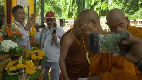 Buddhist-monks-assembly-on-the-occasion-of-Holy-Dalai-Lama's-88th-birthday-at-the-sacred-Mahabodhi-Temple-Complex,-Indian-media-journalists-covering-the-Buddhist-gathering