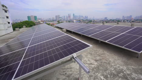 An-Array-Of-Solar-Panels-On-Top-Of-A-Rooftop-Building-With-Cityscape-In-The-Background