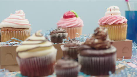 Hero-shot-of-a-group-of-fancy-decorated-cupcakes-on-a-pastel-background