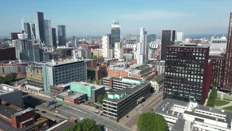Aerial-drone-flight-crossing-over-the-Mancunian-Way-and-Oxford-Road-rooftops-with-a-view-of-Deansgate-Towers