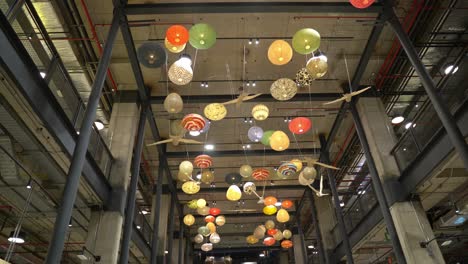Wide-panoramic-view-of-the-ceilings-decorated-with-birds-and-balloons-of-the-Asian-culture-at-the-MUT-Tobalaba-Urban-Market,-Santiago,-Chile