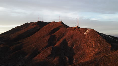 Aerial-parallax-tilt-up-of-El-Paso-mountains-with-radio-towers-at-sunset