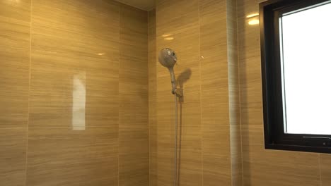 Simple-White-Shower-Head-in-Bathroom-with-Granite-Tile-Wall