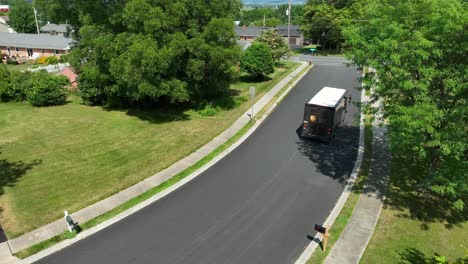 Aerial-tracking-shot-of-UPS-truck-driving-in-residential-neighborhood-in-America