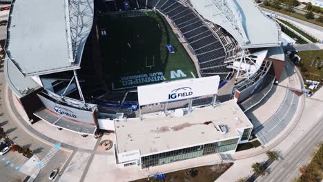 Rising-Parallax-Drone-Shot-of-IG-Investors-Group-Field-University-of-Manitoba-Winnipeg-Blue-Bombers-Football-and-Soccer-Concert-Stadium-Arena-in-Canada