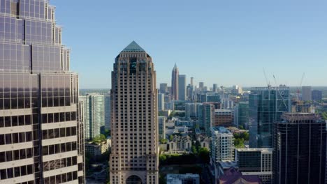 Drone-shot-of-downtown-Atlanta,-Georgia-slowly-flying-behind-a-skyscraper