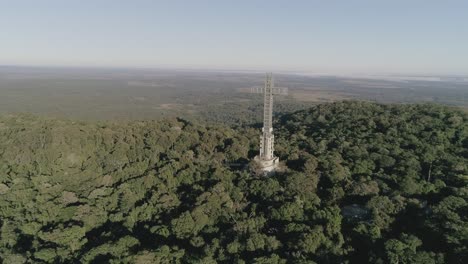 Drone-long-shot-flying-towards-the-Cruz-de-Santa-Ana-surrounded-by-deep-natural-forest-in-Misiones,-Argentina