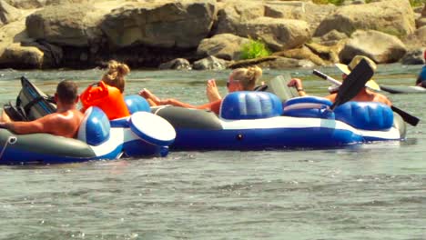 People-floating-on-a-river-on-a-hot-summer-day