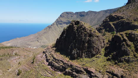 Tamadaba-Natural-Park,-Tirma:-aerial-view-in-orbit-of-rock-formations-in-this-natural-park-on-the-island-of-Gran-Canaria-on-a-sunny-day