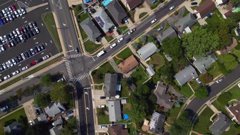 A-top-down-drone-view-over-a-suburban-neighborhood-on-Long-Island,-New-York-on-a-sunny-day