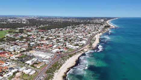 Aerial-landscape-video-above-Trigg-Beach-in-Perth,-Western-Australia-with-the-city-in-the-background
