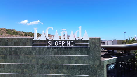 Aerial-view-of-La-Cañada-shopping-mall,-big-shopping-center-in-Marbella-Malaga-Spain,-4K-shot