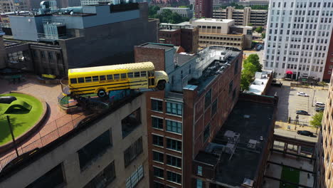 Aerial-view-around-the-yellow-coach-on-top-of-the-City-Museum,-in-St-Louis,-USA