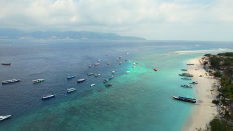Many-Passenger-Travel-Tour-Boats-Moored-on-the-Shores-of-Tropical-Gili-Trawangan-Island-in-Lombok-Indonesia,-Aerial-view