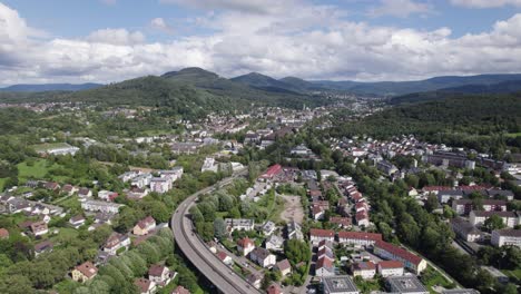 Aerial-view-across-Baden-Baden-Waldseestraße-alongside-old-spa-town-in-Germany-towards-Black-forest-mountain-range