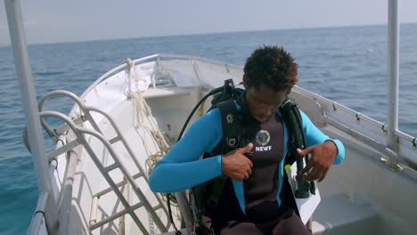Scuba-Diver-Straps-On-Tank-And-Buoyancy-Control-Device-Before-Diving-Into-The-Indian-Ocean-In-Kenya