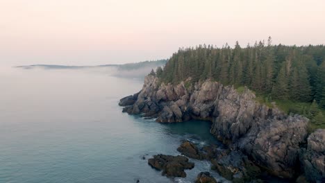 Gorgeous-Aerial-View-Captures-Maine's-Rugged-Cliffs-Shrouded-in-Dawn-Fog