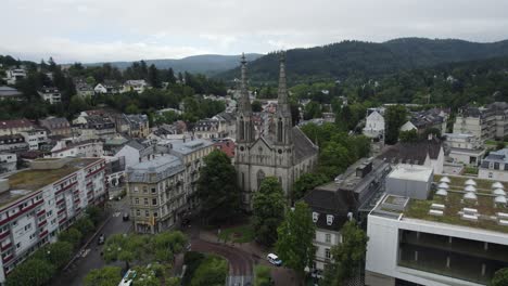 Aerial-view-circling-Stadtkirche-evangelical-church-in-Baden-Baden-town-centre,-Germany