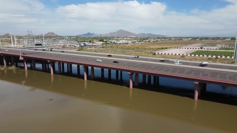 Drone-ascending-above-Highway-202-in-Tempe-Arizona-,-salt-River-and-Camelback-Mountain