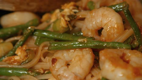 Close-Up-of-Pad-Thai-with-King-Prawns,-Noodles-and-Beans