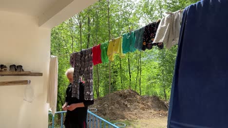 colorful-washed-clothes-on-laundry-line-rope-to-dry-outside-a-rural-house-after-outdoor-activity-nature-camping-hand-wash-concept-in-camping-and-living-village-lifestyle-country-side-forest-mountain