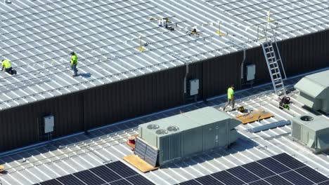 Männer,-Die-An-Einem-Industriegebäude-Arbeiten-Und-Sonnenkollektoren-Auf-Dem-Dach-Installieren