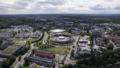 Aerial-view-orbiting-colourful-Baden-Baden-Gewerbepark-modern-shopping-Cité-futuristic-skyline