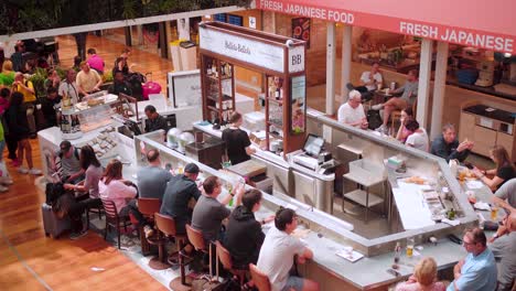 Inside-Paris-Charles-de-Gaulle-Airport:-Busy-Traveler-Enjoying-Meal-at-Modern-Food-Court,-Authentic-French-Cuisine-and-International-Food-Options-Available