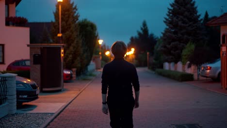 Young-Man-Walking-In-Middle-Peacefully-On-Empty-Street-At-Evening-Time