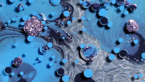 Abstract-art-background-of-swirling-blue-and-black-colors,-paint-bubbles-burst-and-react-with-glitter