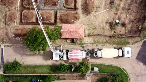 Top-down-view-of-cement-mixer-trucks-delivering-concrete-to-building-plot