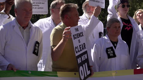 Television-presenter-and-campaigner-Chris-Packham-stands-holding-a-“No-New-Oil”-placard-with-a-group-of-scientists-on-a-protest-calling-for-no-new-exploration-or-licences