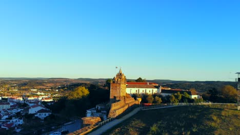 Drone-shot-of-a-medievel-tower-on-a-hill-in-Alentejo,-Portugal
