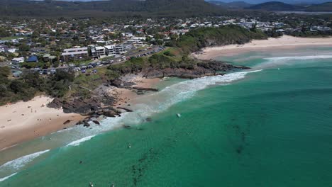 Aerial-View-Of-Surfers-At-Cabarita-Beach-In-New-South-Wales,-Australia---drone-shot
