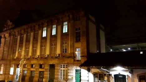 Woman-walking-alone-down-serene-street-next-to-Sao-Bento-Station-in-Porto-at-night
