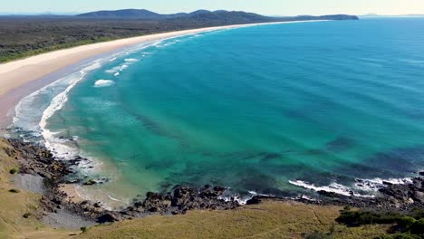 Drone-aerial-landscape-shot-of-beautiful-ocean-sandy-bushland-beach-waves-Goolawah-Crescent-Head-Kempsey-travel-tourism-NSW-Australia-4K