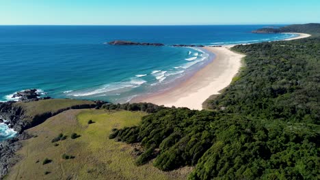 Drone-aerial-landscape-scenery-beach-bushland-rocky-headland-ocean-waves-sand-travel-tourism-Crescent-head-Kempsey-NSW-Australia-4K
