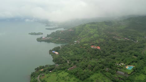 greenery-hill-station-and-small-village-in-near-pawana-lake-drone-view-from-dark-clouds