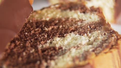 A-Smooth-Reveal-Shot-Of-A-Sliced-Marble-Cake-Topped-With-Chocolate-Syrup