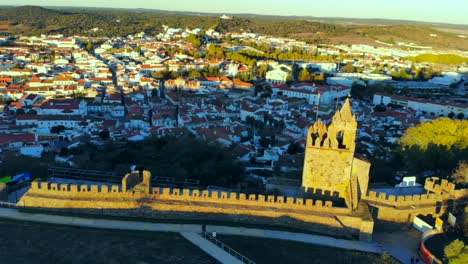 Drone-shot-of-medieval-tower-on-a-hill-in-Aletejo,-Portugal