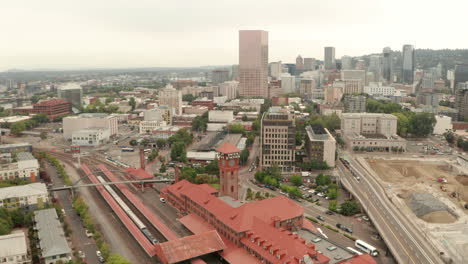 Dolly-back-aerial-shot-over-Union-station-with-Portland-city-in-the-background