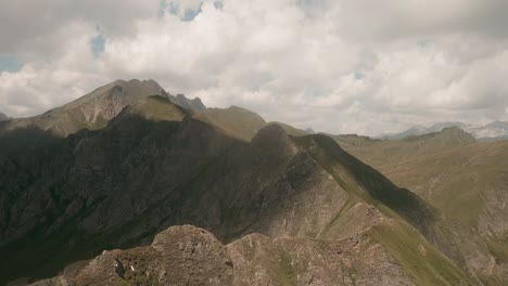 FPV-drone-swiftly-traces-rugged-mountain-ridge-near-Italy's-Kleiner-Seefeldsee,-Gitschberg-area