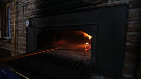 Wood-Fire-Oven-Being-Prepped-For-Baking-Traditional-Italian-Pizza